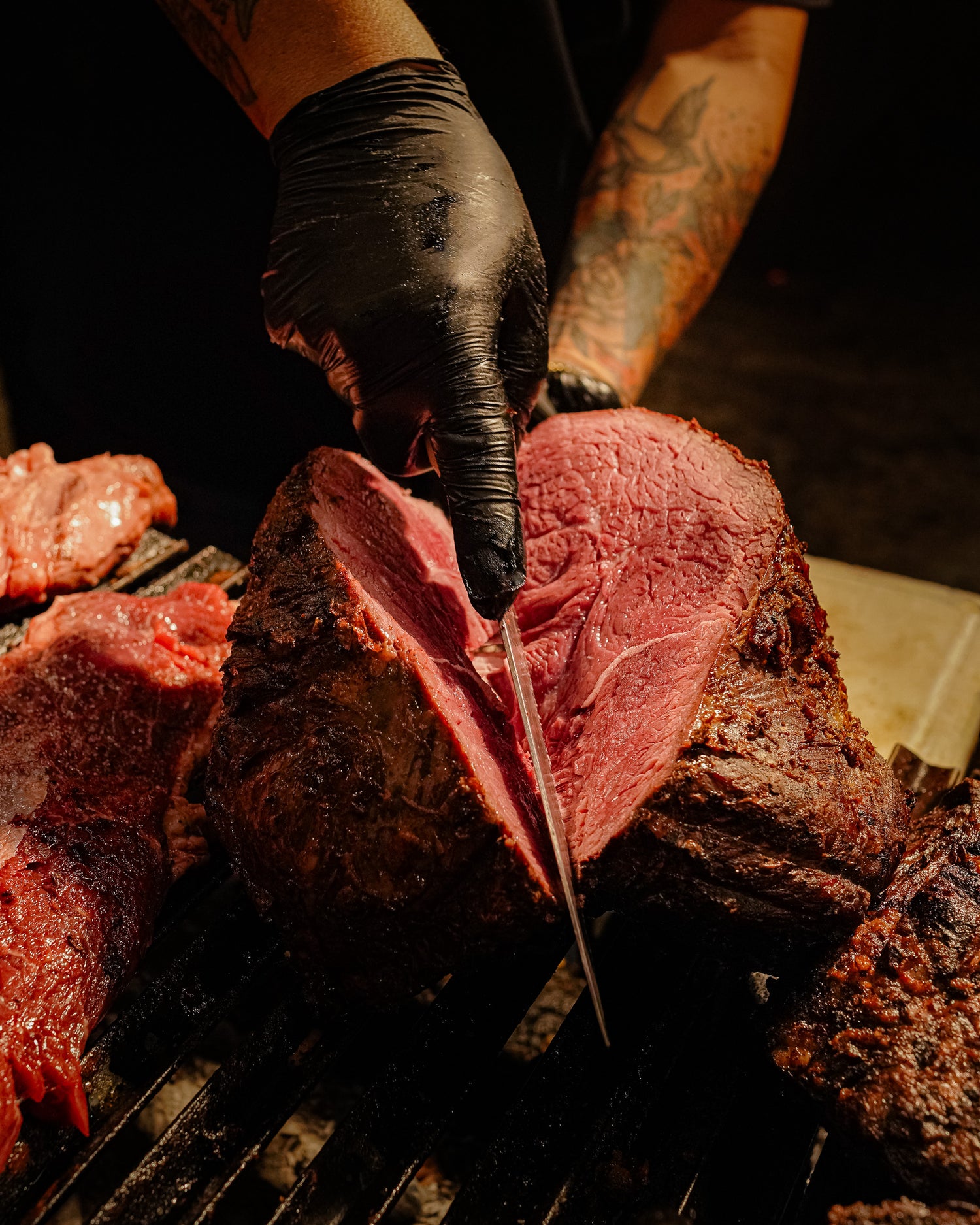 Chef slicing a perfectly grilled ribeye steak