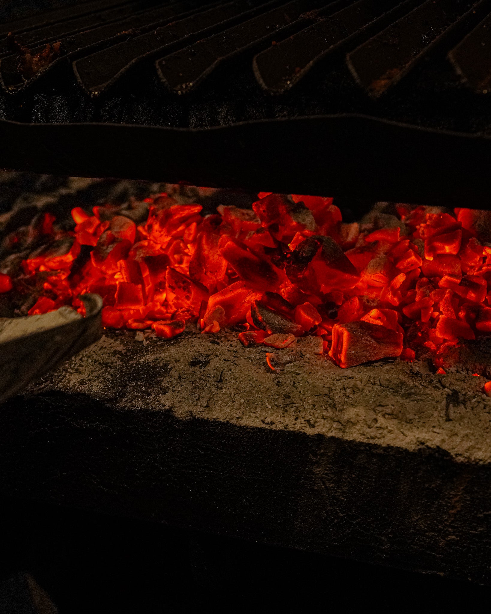 Chef grilling premium meats over open flames